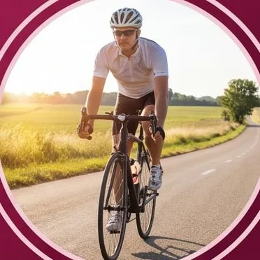 Man riding a road bike past green fields